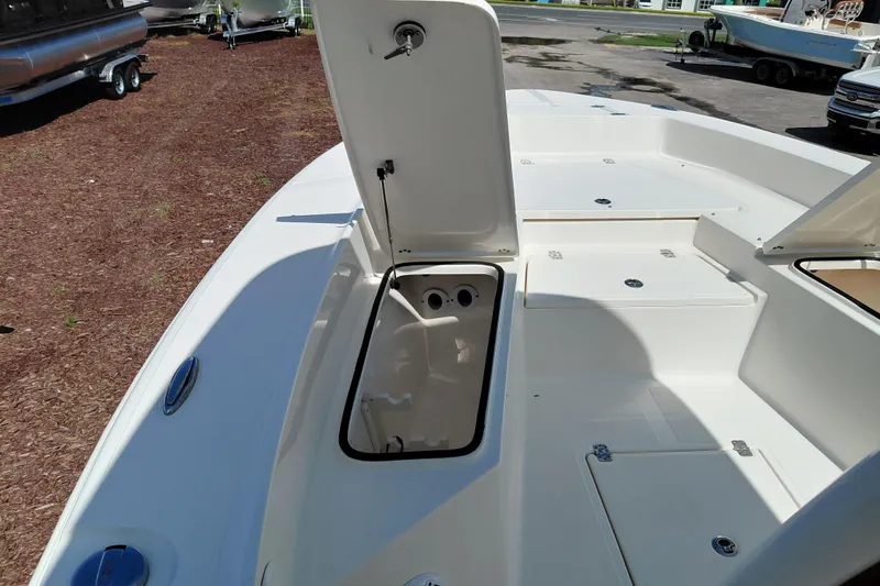 Slide: The Image of 2023 Pioneer 220 Bay Sport boat deck with open storage compartments. - 15