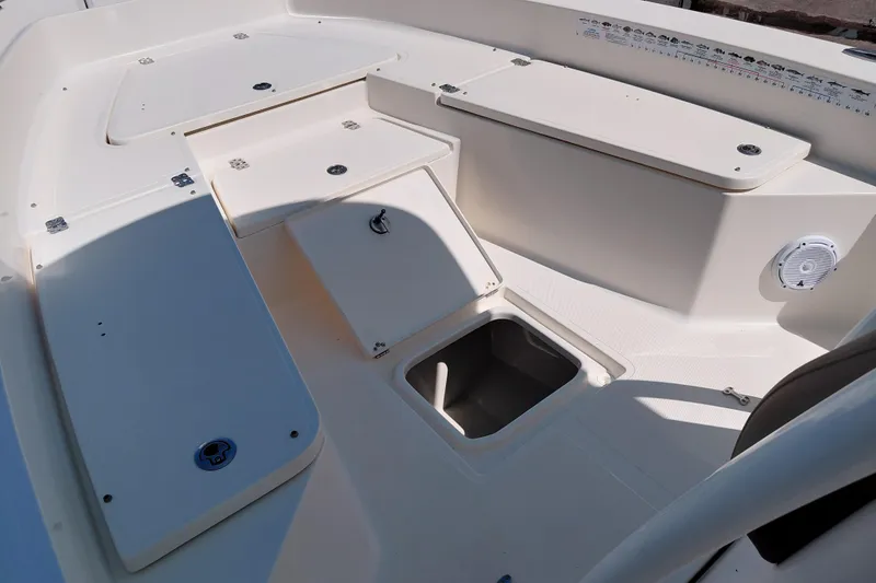 Slide: The Image of 2023 Pioneer 220 Bay Sport boat interior with storage compartments and speaker. - 23
