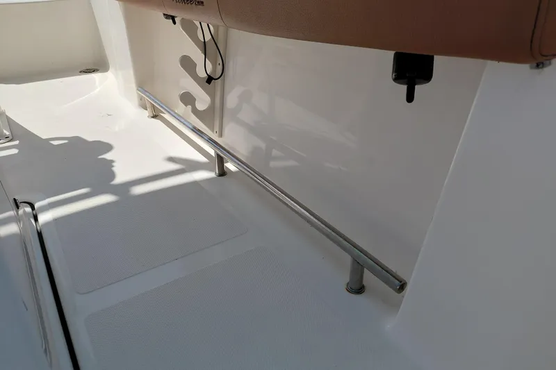 Slide: The Image of 2023 Pioneer 220 Bay Sport boat interior with seating and stainless steel railing. - 33