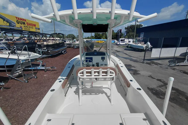 Slide: The Image of 2023 Pioneer 220 Bay Sport boat displayed outdoors at a dealership. - 47