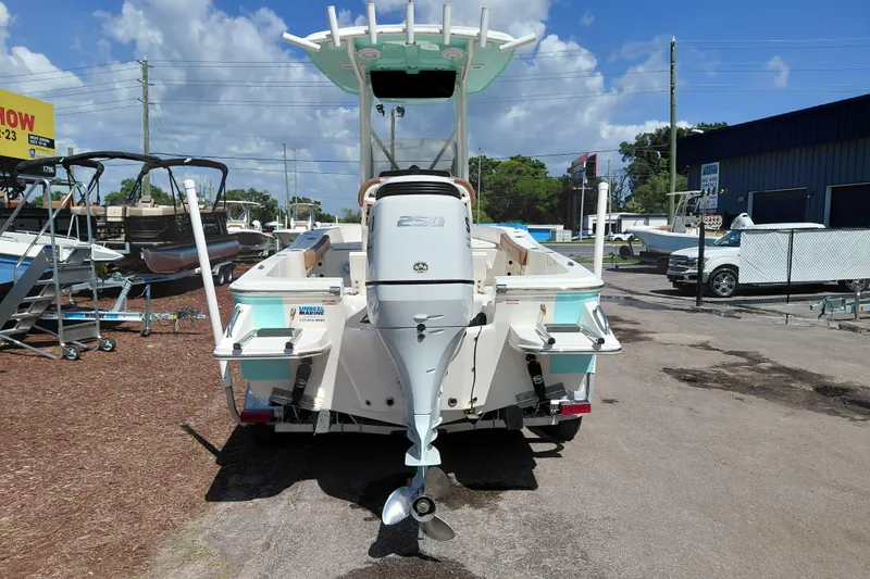 Slide: The Image of 2023 Pioneer 220 Bay Sport boat with powerful outboard motor, displayed outdoors. - 6