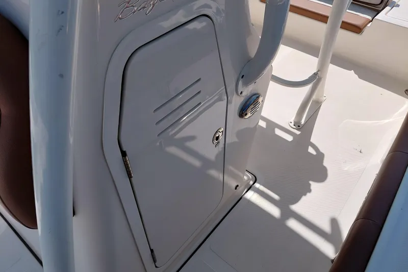 Slide: The Image of 2023 Pioneer 220 Bay Sport boat interior with storage compartment and seating. - 30