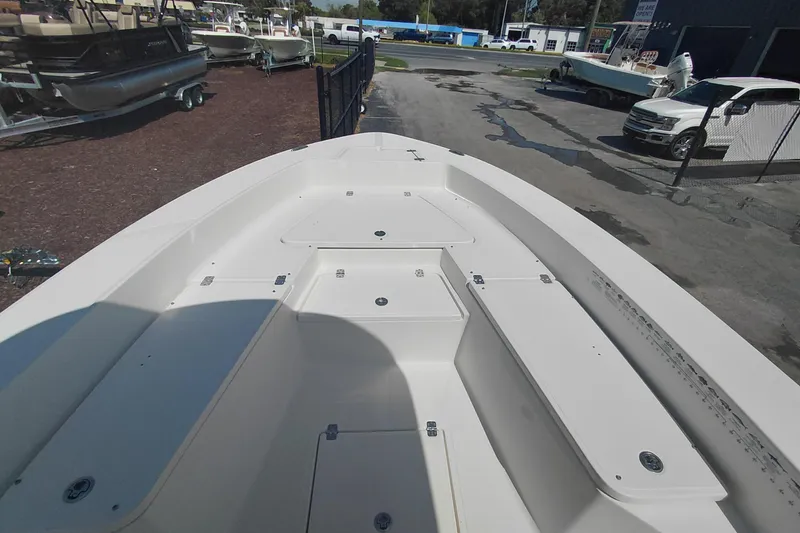 Slide: The Image of 2023 Pioneer 220 Bay Sport boat deck, showcasing spacious storage compartments and sleek design. - 9
