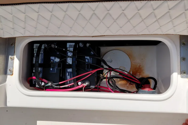 Slide: The Image of Battery compartment of 2023 Pioneer 220 Bay Sport boat with wiring and connections. - 42