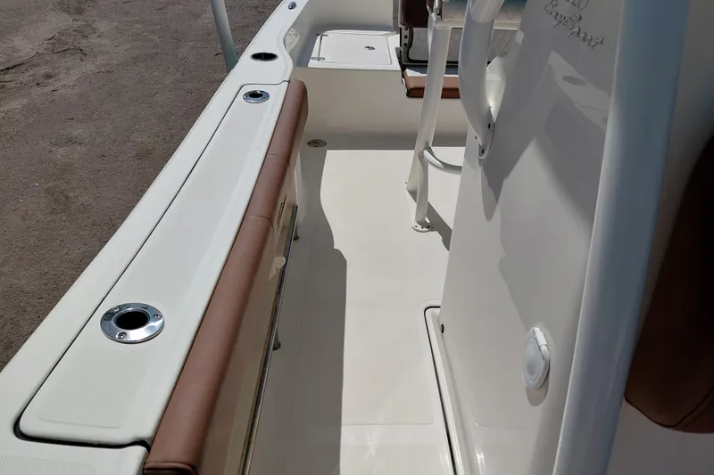 Slide: The Image of 2023 Pioneer 220 Bay Sport boat interior with rod holders and seating. - 28