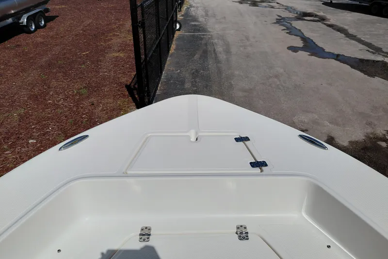 Slide: The Image of 2023 Pioneer 220 Bay Sport boat deck, featuring storage compartments and sleek design. - 55
