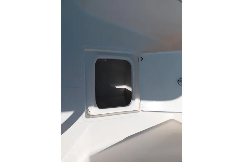 Slide: The Image of Storage compartment on 2023 Pioneer 220 Bay Sport boat, featuring a sleek white interior design. - 20