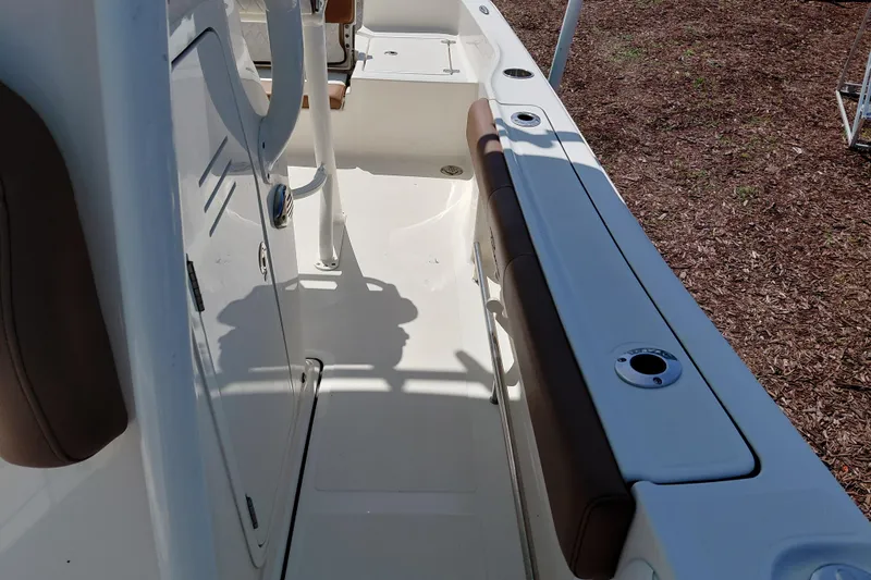 Slide: The Image of 2023 Pioneer 220 Bay Sport boat interior with seating and storage compartments. - 27