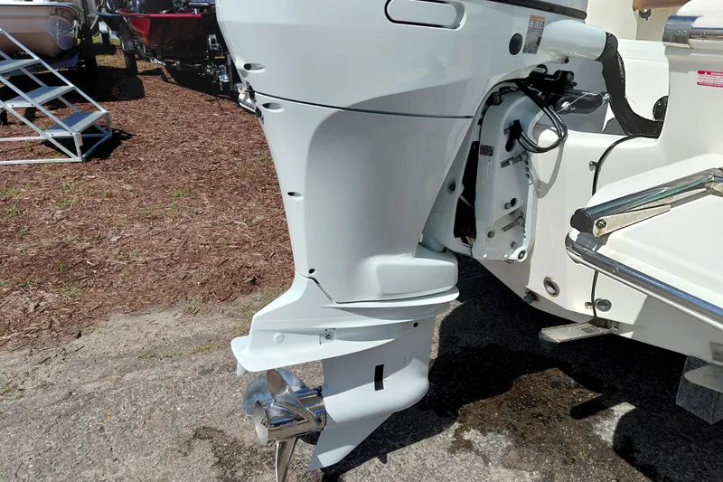 Slide: The Image of Outboard motor of 2023 Pioneer 220 Bay Sport boat displayed outdoors. - 57