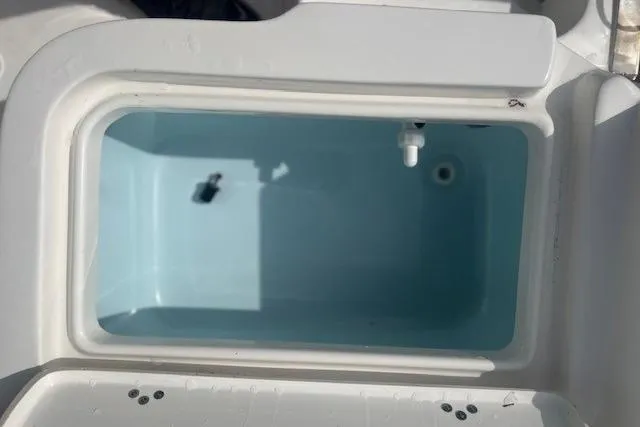 Slide: The Image of 2024 Key West 1720 Center Console livewell, open lid, white interior. - 11