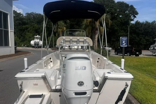 Slide: The Image of 2024 Key West 1720 Center Console boat with outboard motor, parked outdoors. - 4