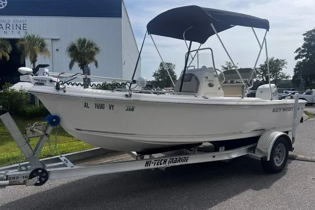 The Image of 2024 Key West 1720 Center Console boat on trailer, parked outdoors near marine center. - 1