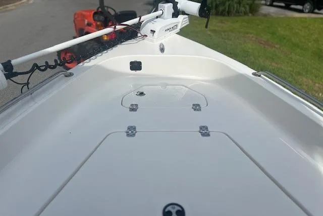 Slide: The Image of 2024 Key West 1720 Center Console boat deck with trolling motor, parked outdoors. - 7