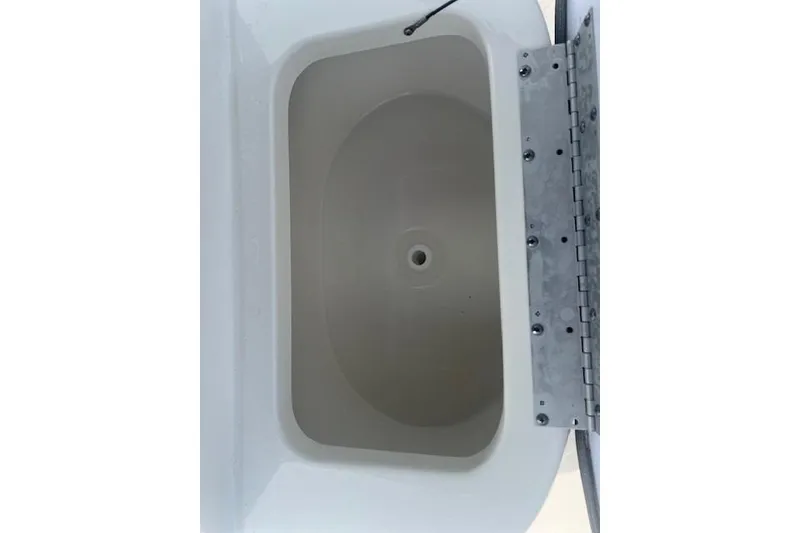 Slide: The Image of 2024 Key West 1720 Center Console boat storage compartment, open lid view. - 9