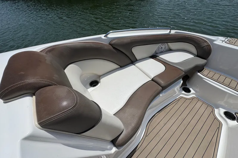 Slide: The Image of Luxurious seating on 2011 Yamaha Boats 242 Limited, featuring brown and white upholstery. - 12