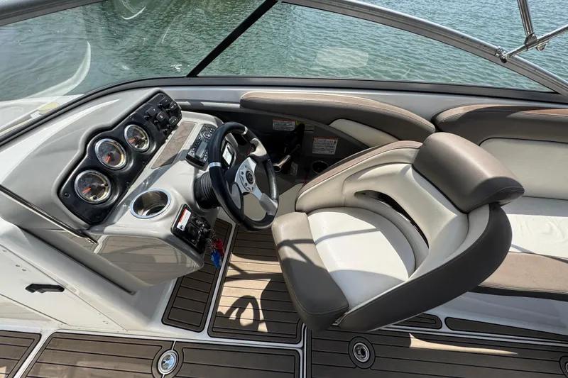 Slide: The Image of 2011 Yamaha Boats 242 Limited cockpit with steering wheel and gauges, overlooking water. - 15