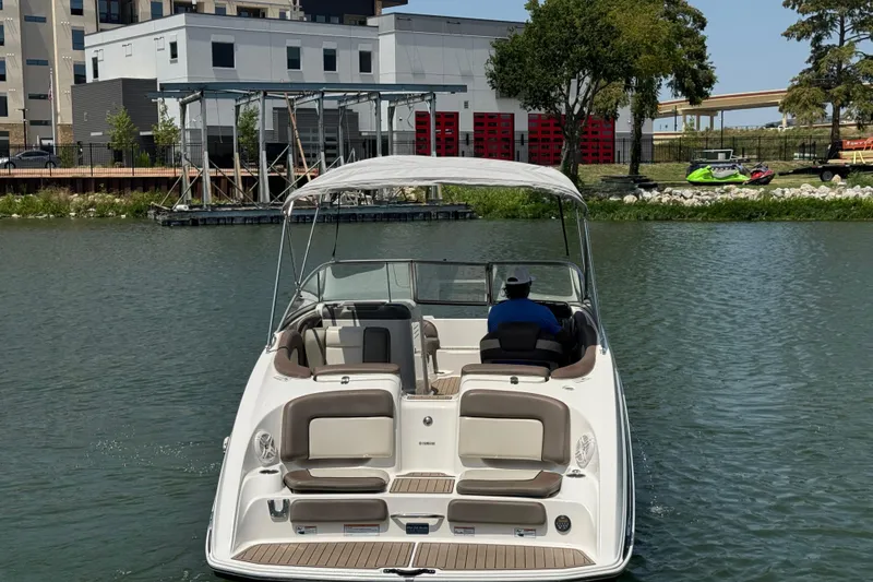 Slide: The Image of 2011 Yamaha Boats 242 Limited cruising on a calm river near urban buildings. - 7