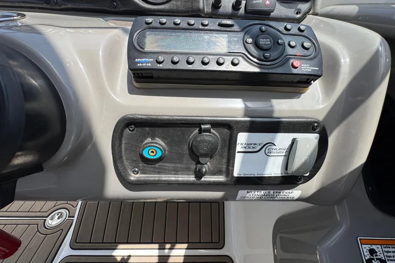 Slide: The Image of Control panel of a 2011 Yamaha Boats 242 Limited, featuring audio system and cruise assist. - 17
