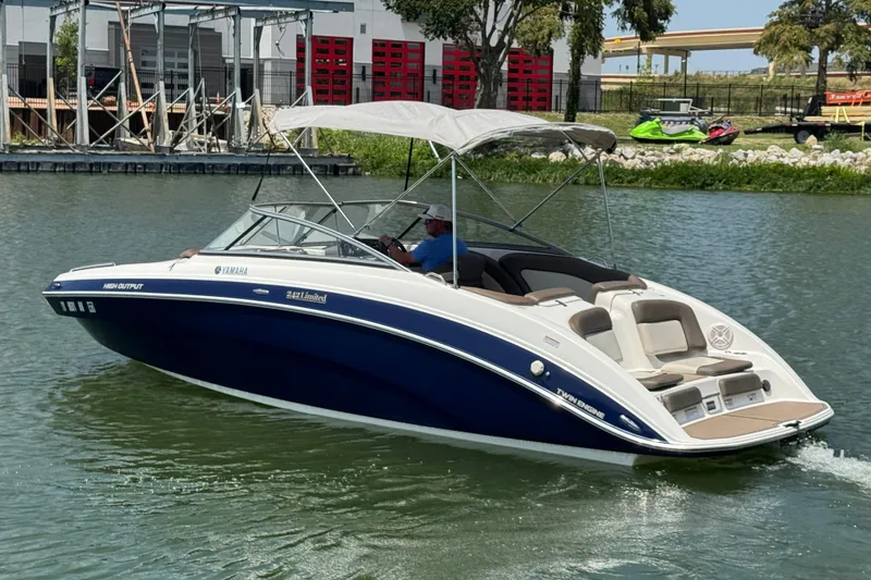 Slide: The Image of 2011 Yamaha Boats 242 Limited cruising on a calm waterway with canopy open. - 8