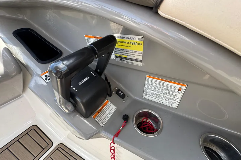 Slide: The Image of Yamaha Boats 2011 242 Limited control panel with throttle and safety warnings. - 16