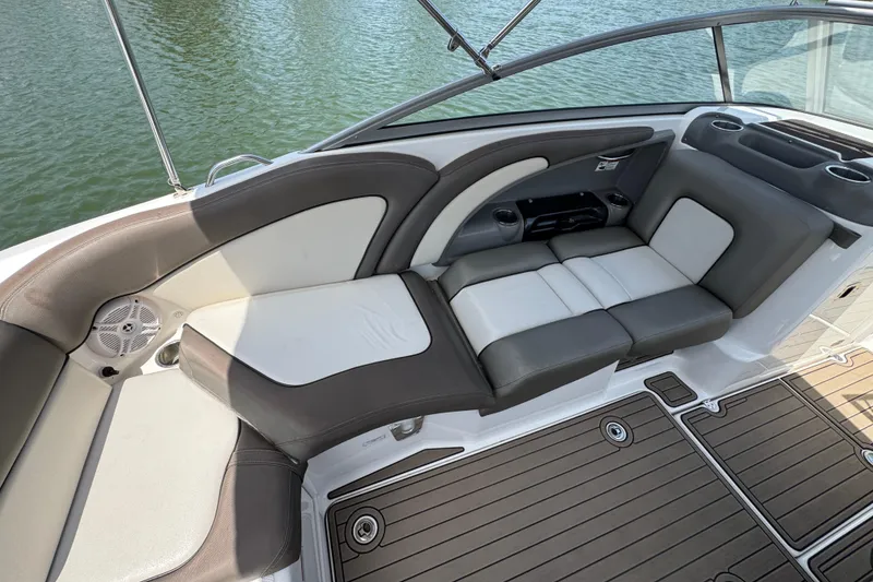 Slide: The Image of 2011 Yamaha Boats 242 Limited interior seating with gray and white upholstery on water. - 20