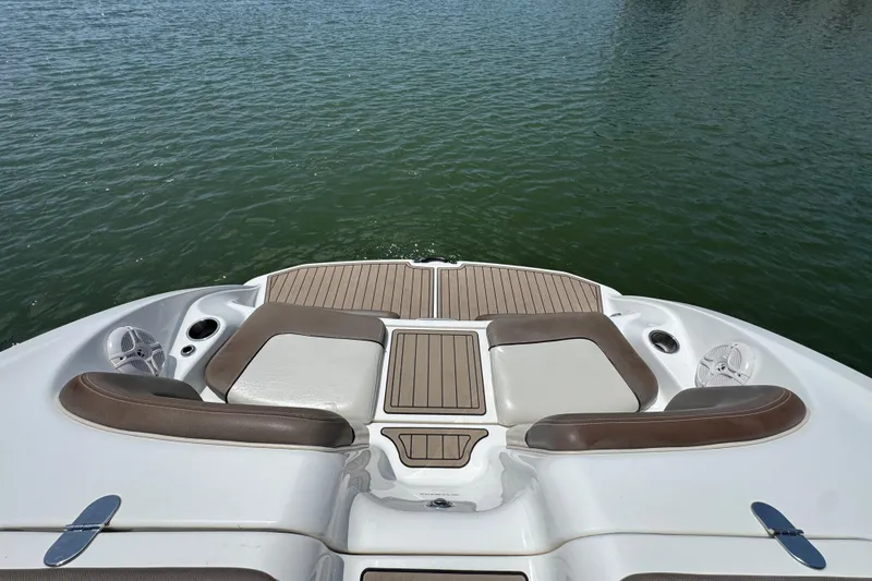 Slide: The Image of 2011 Yamaha Boats 242 Limited swim platform with cushioned seating on calm water. - 22