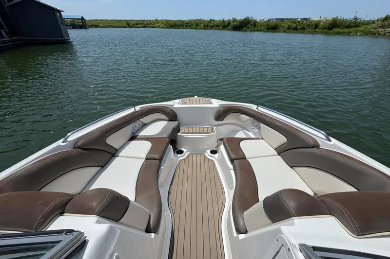 Slide: The Image of 2011 Yamaha Boats 242 Limited bow seating area on calm water. - 10