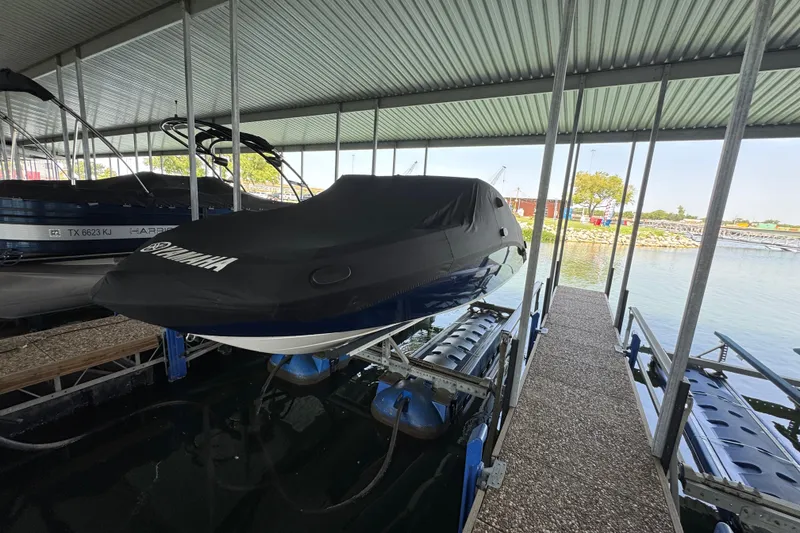 Slide: The Image of 2011 Yamaha Boats 242 Limited covered in a docked marina setting. - 27