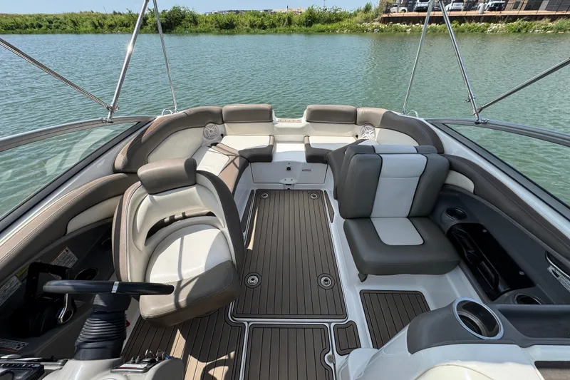 Slide: The Image of 2011 Yamaha Boats 242 Limited interior with plush seating on a serene lake. - 14