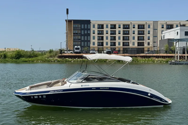 The Image of 2011 Yamaha Boats 242 Limited on water, with modern buildings in the background. - 3