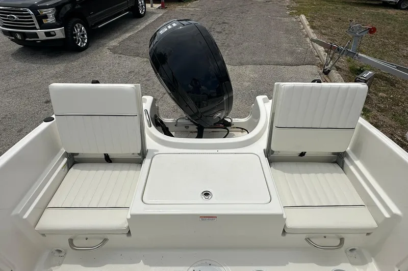 Slide: The Image of 2025 Bayliner Trophy T18 boat interior with seating and outboard motor. - 24