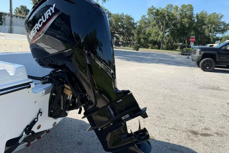 Slide: The Image of 2025 Bayliner Trophy T18 with Mercury outboard motor in a sunny outdoor setting. - 33