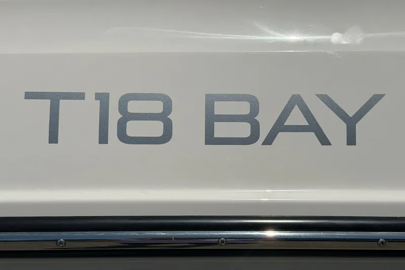 Slide: The Image of 2025 Bayliner Trophy T18 boat logo on white surface. - 37