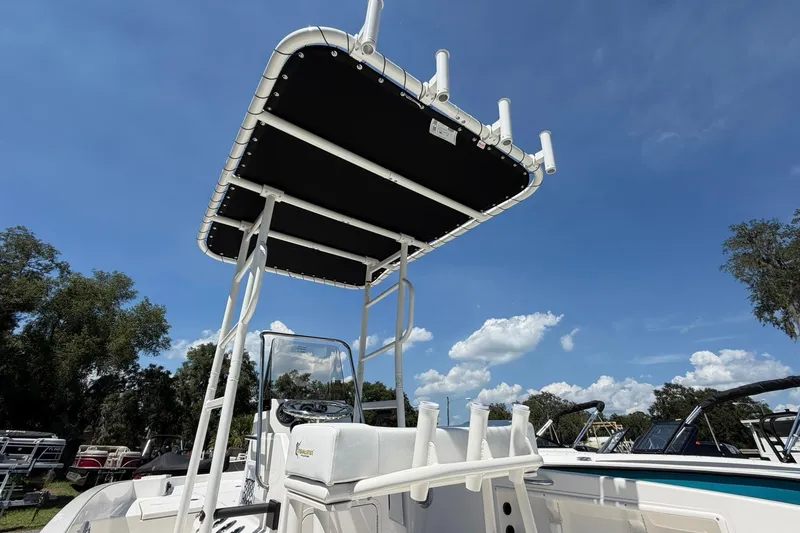 Slide: The Image of 2025 Bayliner Trophy T18 boat with T-top under clear blue sky. - 29
