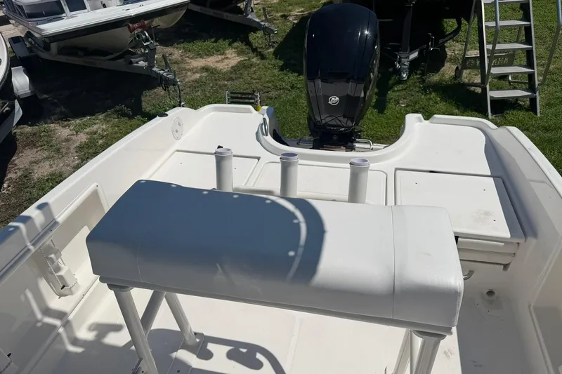Slide: The Image of 2025 Bayliner Trophy T18 boat interior with motor, showcasing seating and deck layout. - 22