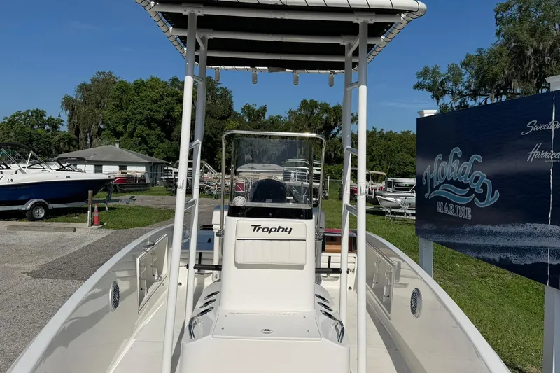 Slide: The Image of 2025 Bayliner Trophy T18 boat at Holiday Marine dealership, sunny day. - 6