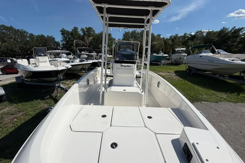 Slide: The Image of 2025 Bayliner Trophy T18 boat displayed outdoors, surrounded by other boats and greenery. - 5