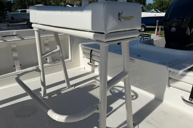 Slide: The Image of 2025 Bayliner Trophy T18 boat interior with white seating and fishing equipment. - 20