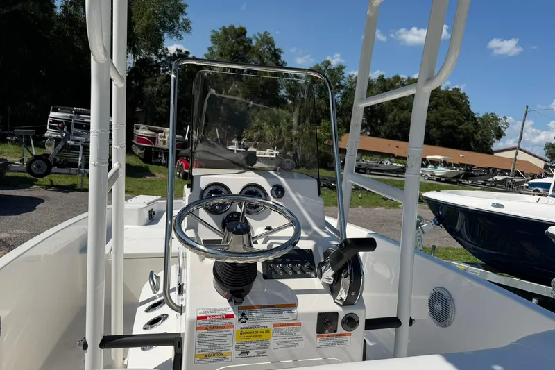 Slide: The Image of The image shows the helm of a 2025 Bayliner Trophy T18 boat, featuring a clear view of the steering wheel and instruments. - 9