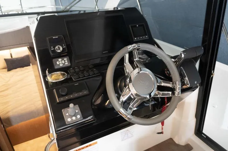 Slide: The Image of Helm of 2026 Beneteau Antares 11 Coupe with modern controls and sleek design. - 18