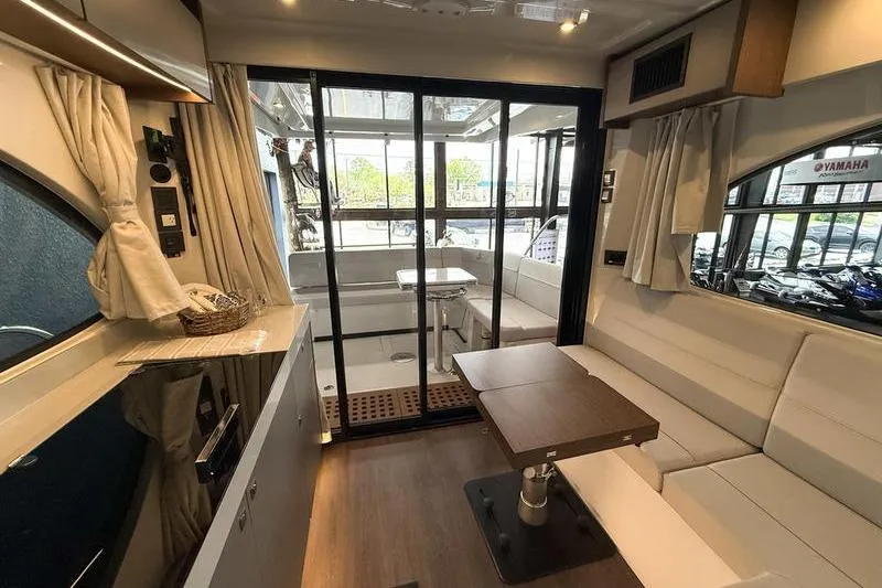 Slide: The Image of Interior of 2026 Beneteau Antares 11 Coupe with modern seating and dining area. - 20