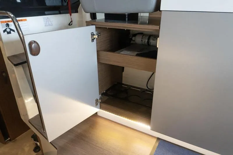 Slide: The Image of Open cabinet in 2026 Beneteau Antares 11 Coupe interior, showcasing storage space. - 13