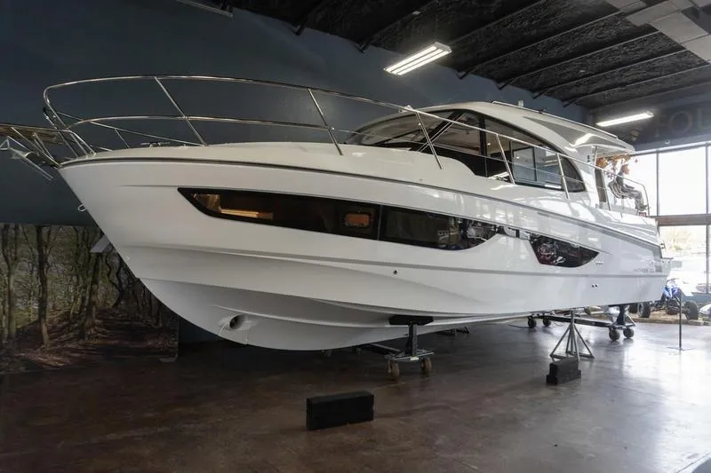 Slide: The Image of 2026 Beneteau Antares 11 Coupe yacht displayed indoors, showcasing sleek design and modern features. - 3