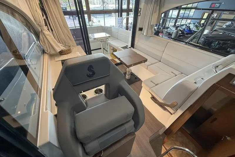Slide: The Image of Interior of 2026 Beneteau Antares 11 Coupe, featuring modern seating and helm station. - 17