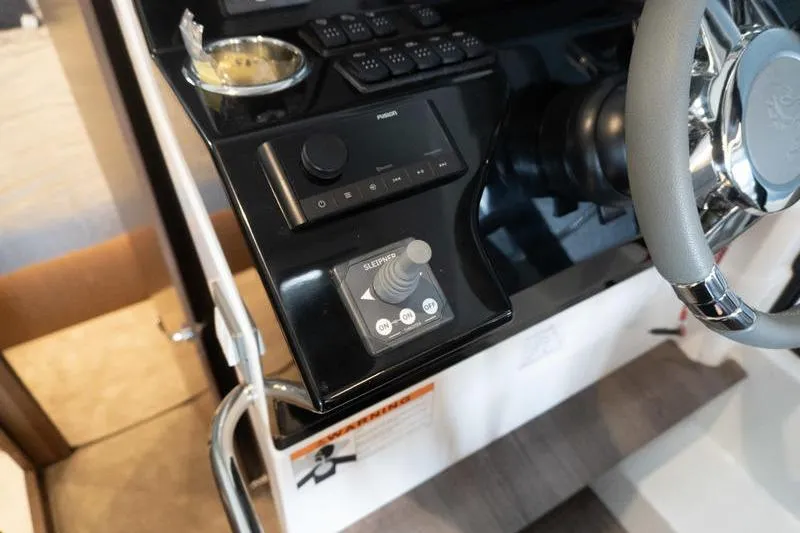 Slide: The Image of Helm controls of 2026 Beneteau Antares 11 Coupe, featuring sleek design and advanced navigation systems. - 19