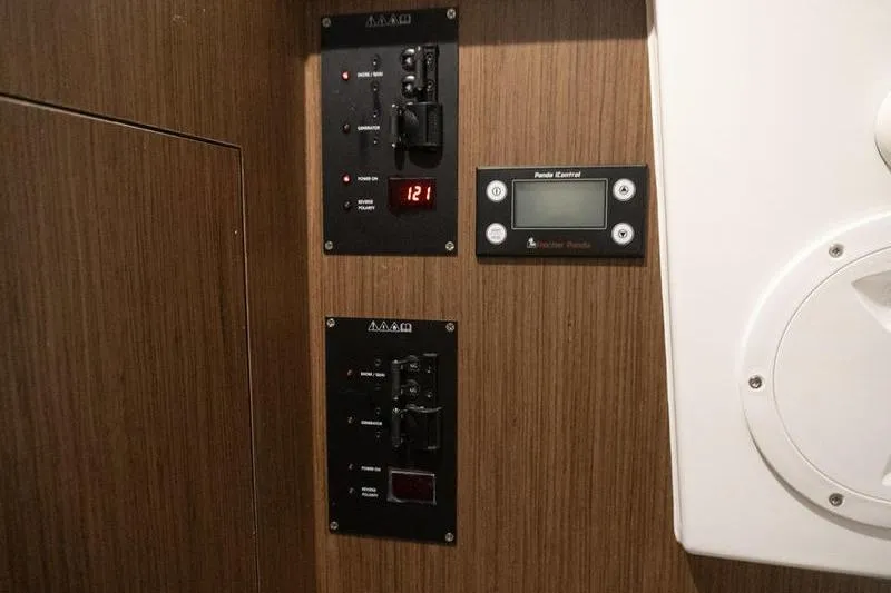 Slide: The Image of Control panel of 2026 Beneteau Antares 11 Coupe, featuring digital displays and switches. - 23