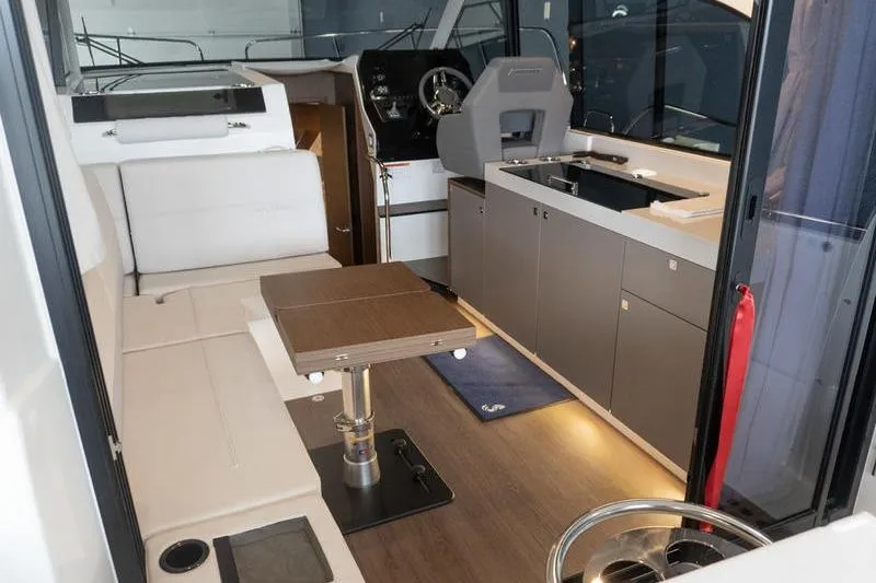 Slide: The Image of Interior of 2026 Beneteau Antares 11 Coupe, featuring modern seating and kitchenette. - 10