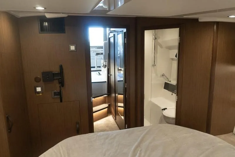 Slide: The Image of Interior of 2026 Beneteau Antares 11 Coupe, featuring modern wood paneling and compact bathroom. - 27