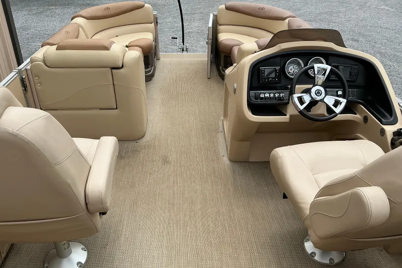 Slide: The Image of Interior of 2019 Avalon Catalina Quad Lounge boat with beige seating and modern dashboard. - 10