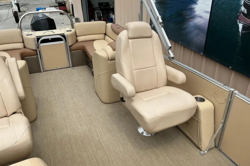 Slide: The Image of 2019 Avalon Catalina Quad Lounge boat interior with beige seating and carpeted floor. - 4